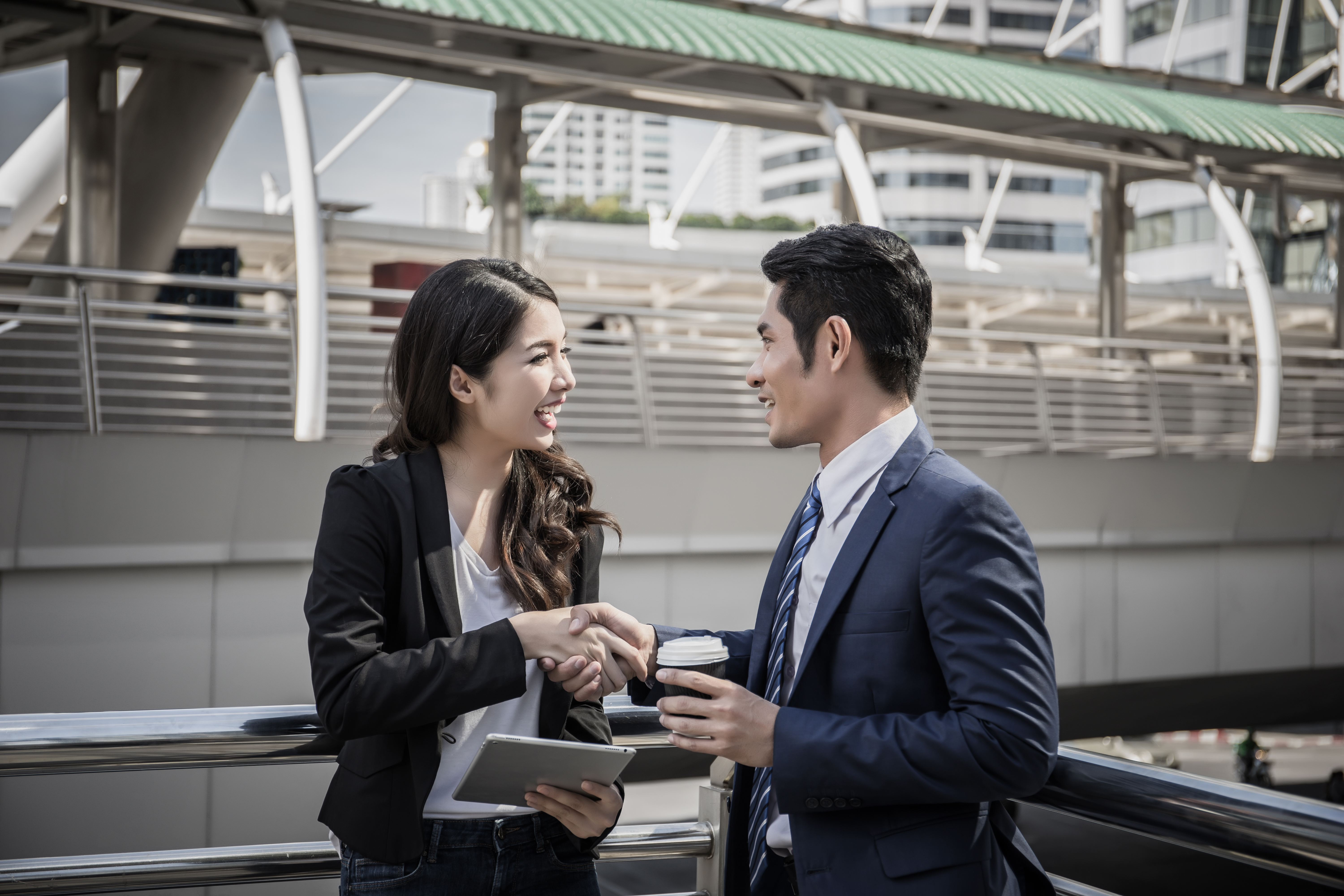 Business partner work hands shaking while looking at successful